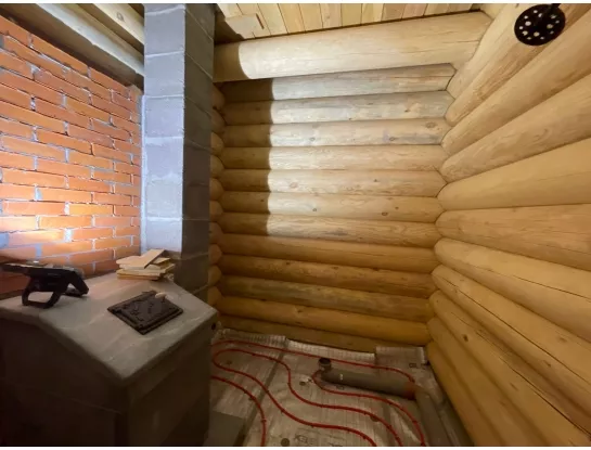 Установка банной печи Колпаков с открытой облицовкой из талькохлорита.